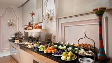 A buffet with various food items and a decorative vase.