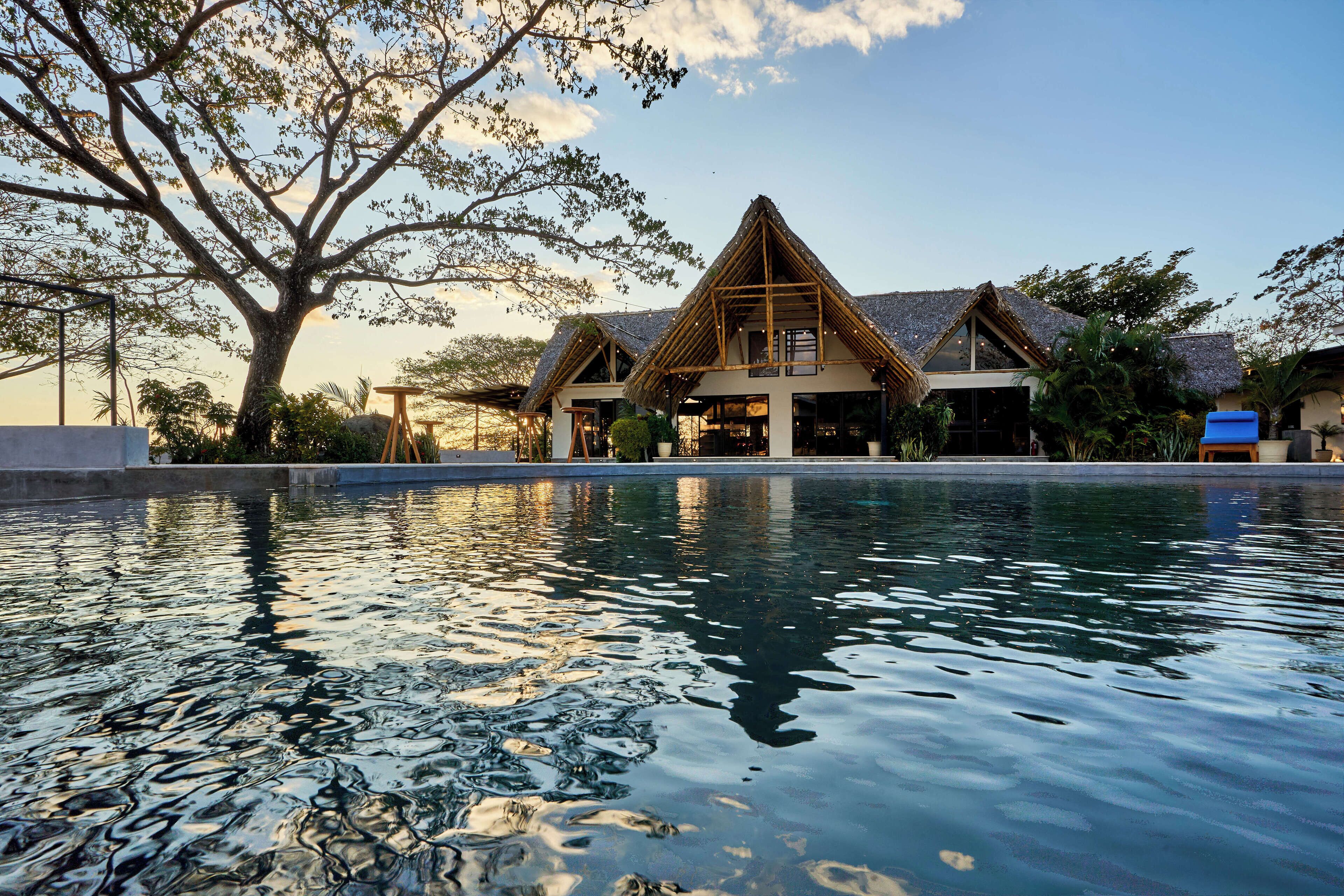 A pool with a house in the background.