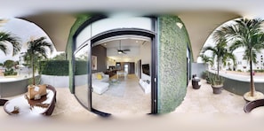 A modern interior with a glass door leading to a living area, a ceiling fan, and a view of the outside.
