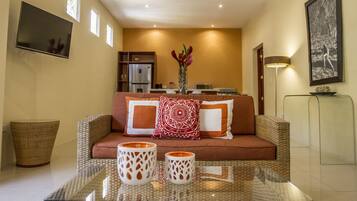 Deluxe Room | Living room | 42-inch Smart TV with cable channels, TV