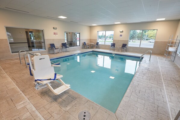 Zona de piscina con vista despejada, una silla de salvavidas y una ventana que da al exterior.
