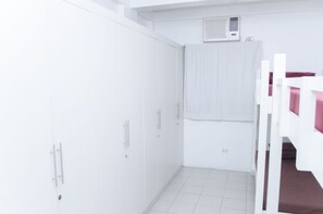 A white room with a bunk bed, a wardrobe, and a curtain. - Tarasa Hostel (Pasay)
