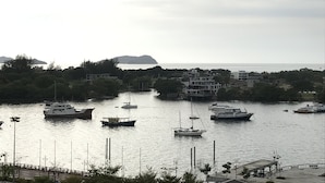 A marina with various boats docked, surrounded by buildings and greenery. - Sunset & Seaview Vacation Condos at Marina Court Resort Condo (Kota Kinabalu)