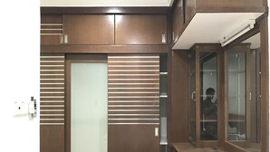A room with a wardrobe featuring horizontal slats, a mirror cabinet, and a built-in shelf. - Sunset & Seaview Vacation Condos at Marina Court Resort Condo (Kota Kinabalu)