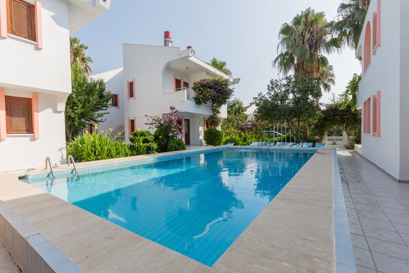 Outdoor pool, open 10:00 AM to 7:00 PM, pool umbrellas, pool loungers