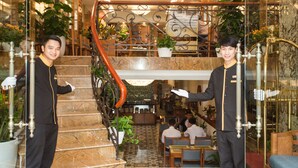 A hotel lobby with a marble staircase, a dining area, and a reception desk. - Hanoi Golden Holiday Hotel (Hanoi)