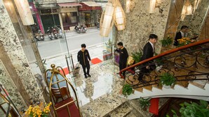 A hotel lobby with a marble floor, a staircase with metal railings, and a view of the street outside. - Hanoi Golden Holiday Hotel (Hanoi)