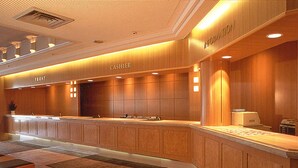 A hotel reception area with a wooden counter, a cash register, and a sign that reads "CASHIER". - Tsumagoi Resort Sai No Sato (Kakegawa)