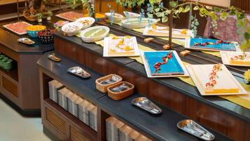 A buffet setup with various food items and utensils.
