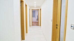 A hallway with wooden doors and white walls. - Rezidence Muzeum (Prague)