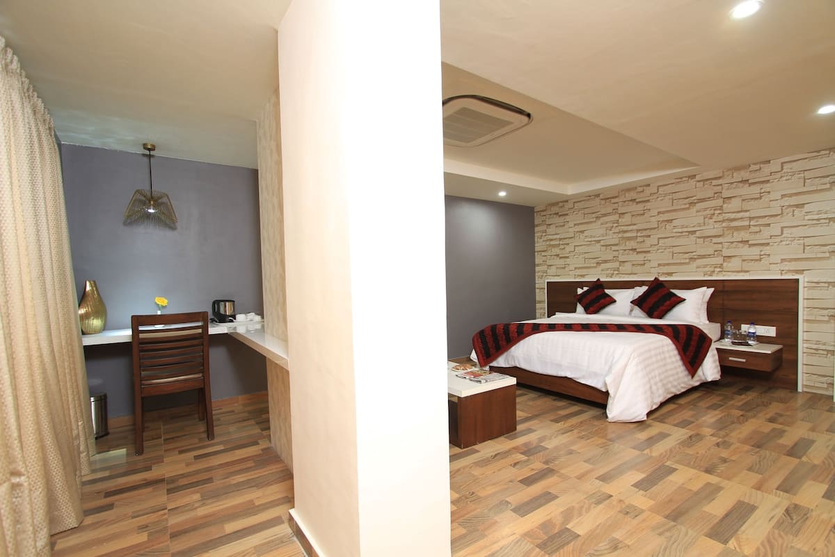 A bedroom with a wooden bed, bedside tables, and a nightstand.