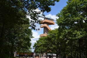 A modern building with a unique architectural design, surrounded by lush green trees. - Campus Boardinghouse Aachen (Aachen)