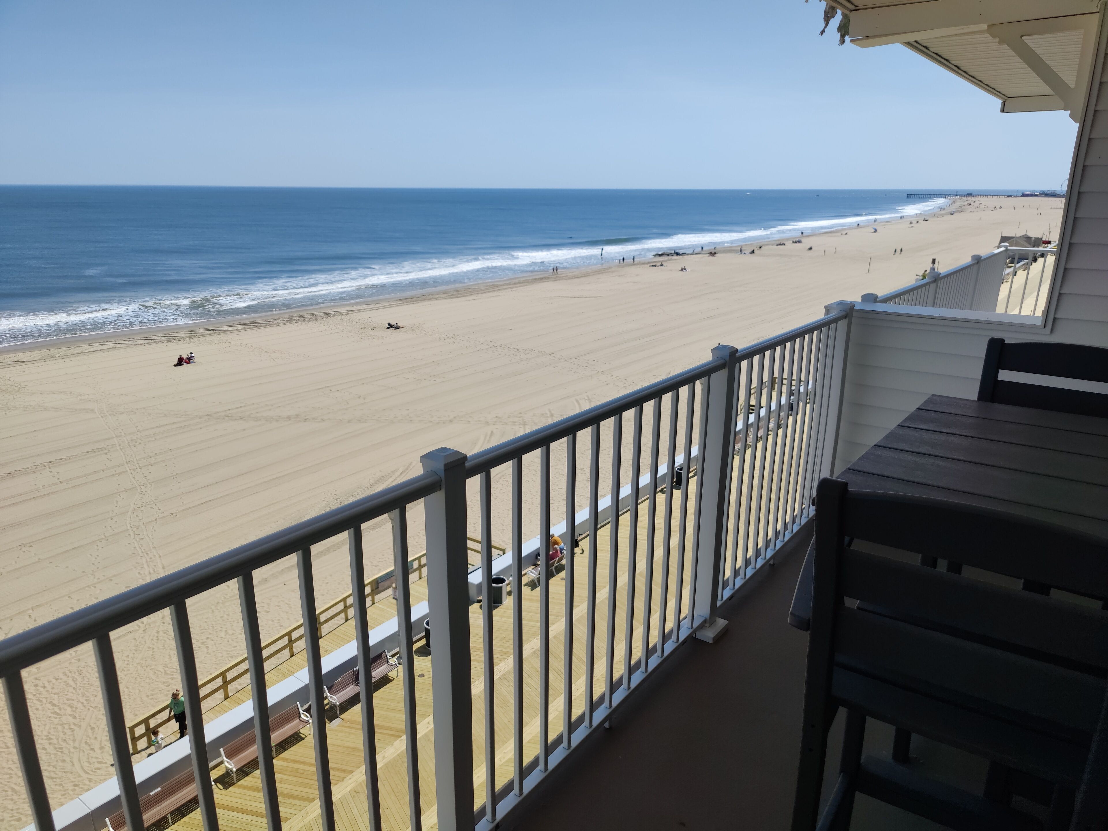 A balcony with a view of a beach and ocean.