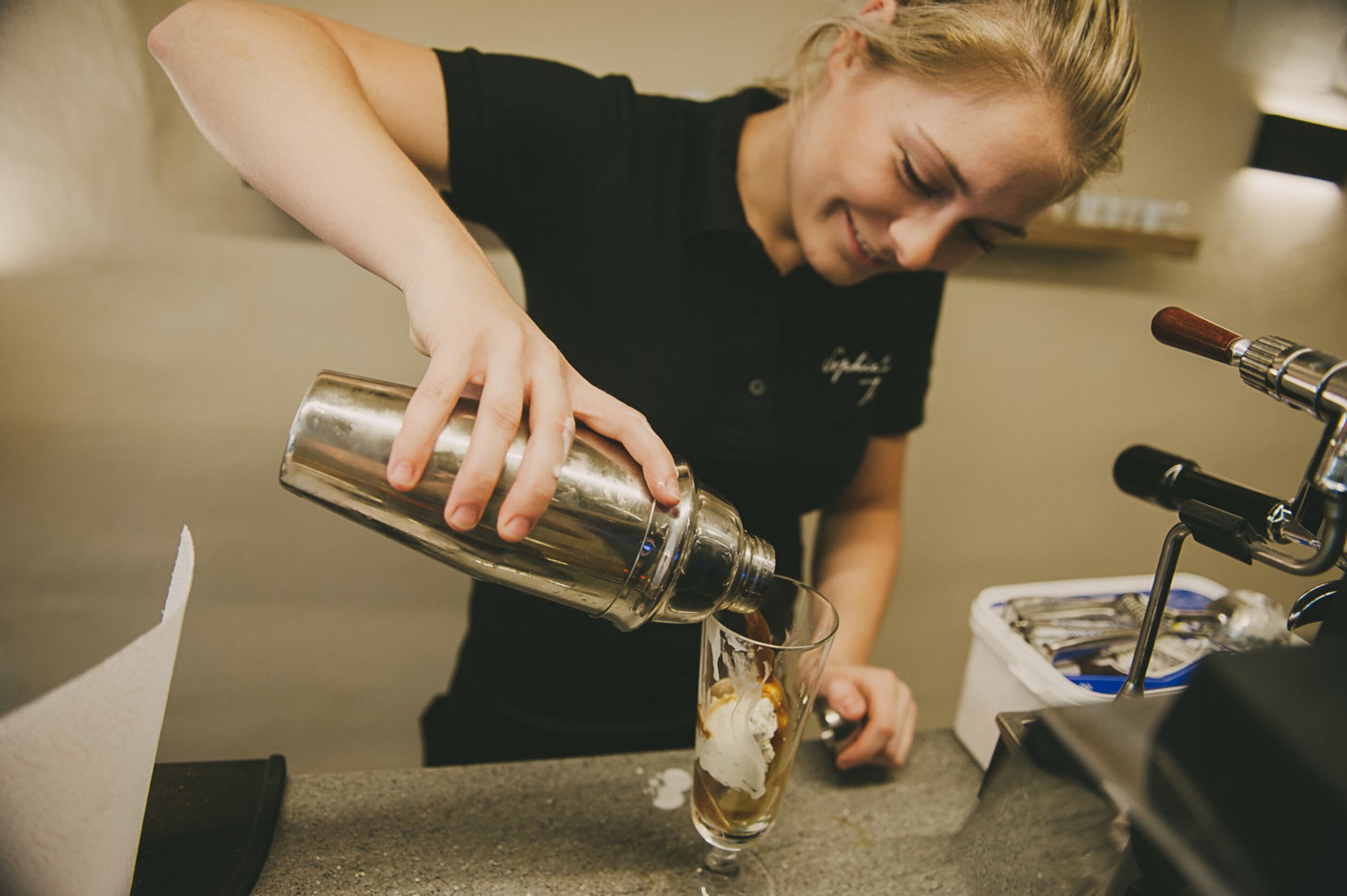 A person pouring a drink into a glass.