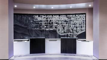 A reception area with a large black and white map, two black podiums, and a modern design.