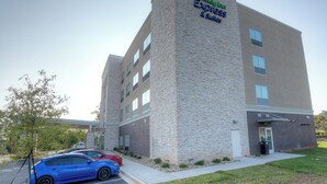 A Holiday Inn Express & Suites building with a stone facade and multiple windows. - Holiday Inn Express & Suites Fort Mill by IHG (Fort Mill)