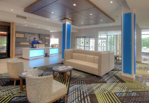 A hotel lobby with a reception desk, seating area, and a patterned carpet. - Holiday Inn Express & Suites Fort Mill by IHG (Fort Mill)
