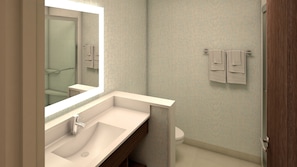 Un baño moderno con un espejo grande, un lavabo y un inodoro.