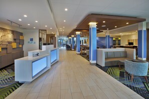 A hotel lobby with a reception desk, seating area, and a check-in counter. - Holiday Inn Express & Suites South Hill by IHG (South Hill)