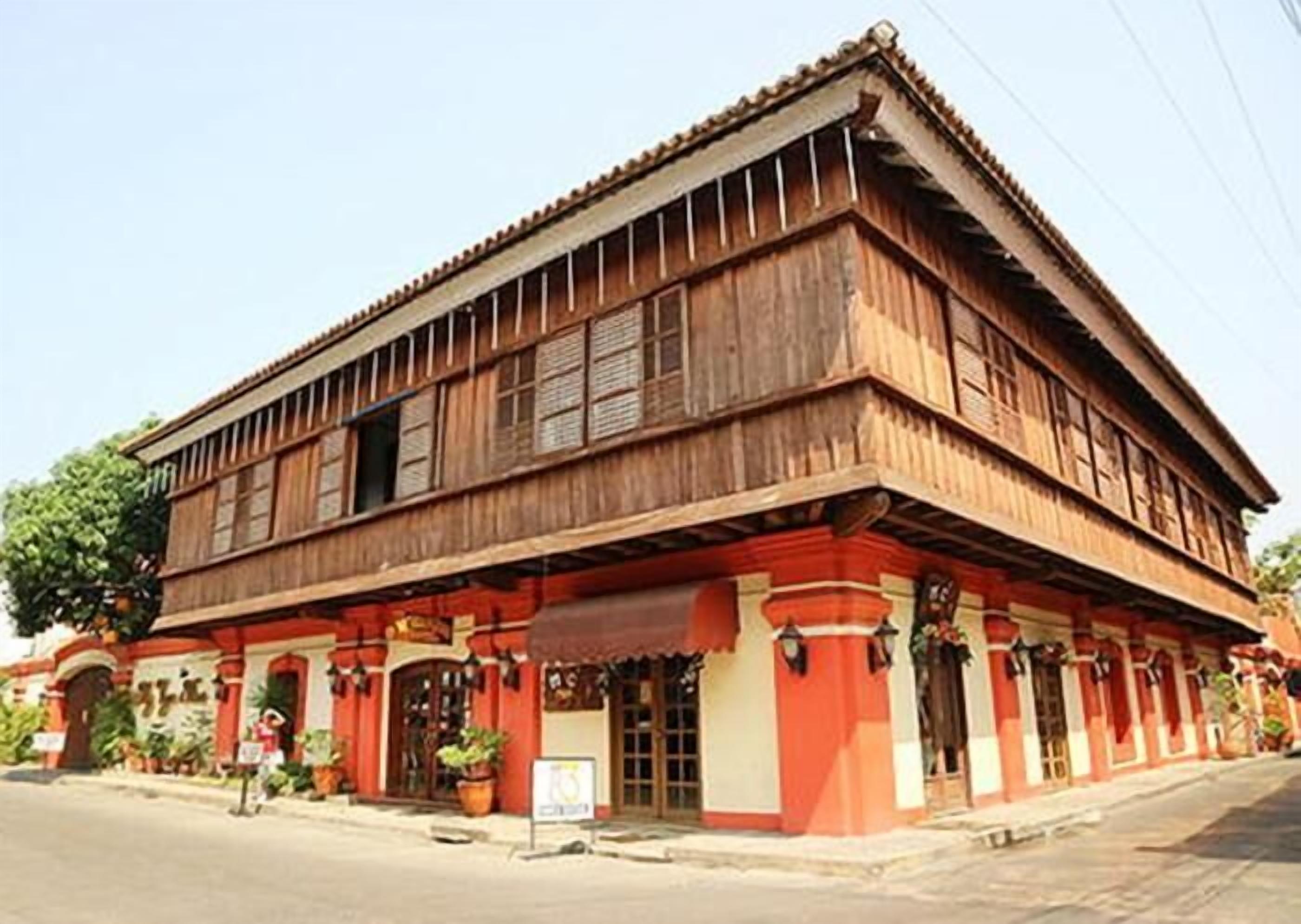 A two-story wooden building with a traditional design, featuring a flat roof and multiple windows.