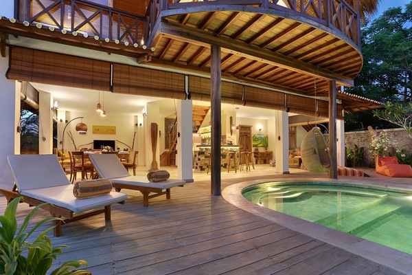 Una piscina al aire libre, sillones reclinables de piscina