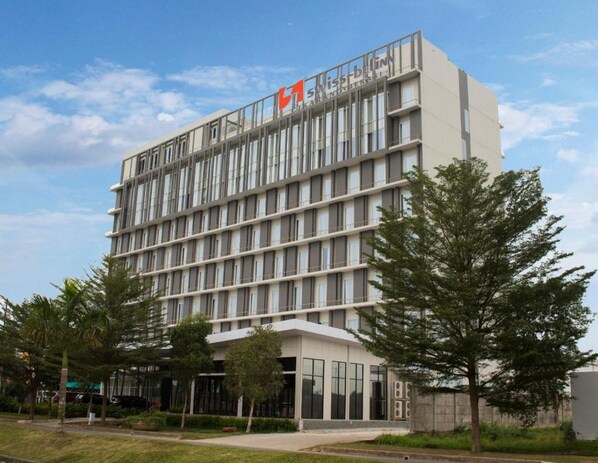 Experience the sleek, contemporary design of SWIST-BEIN, a multi-story hotel with a striking vertical façade.