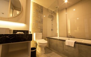 Bathroom features a bathtub, toilet, and vanity with a mirror above.