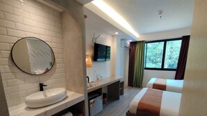 A hotel room with a bathroom, a bed, a TV, and a window with curtains. - Villa Israel Eco Park El nido Palawan (El Nido)