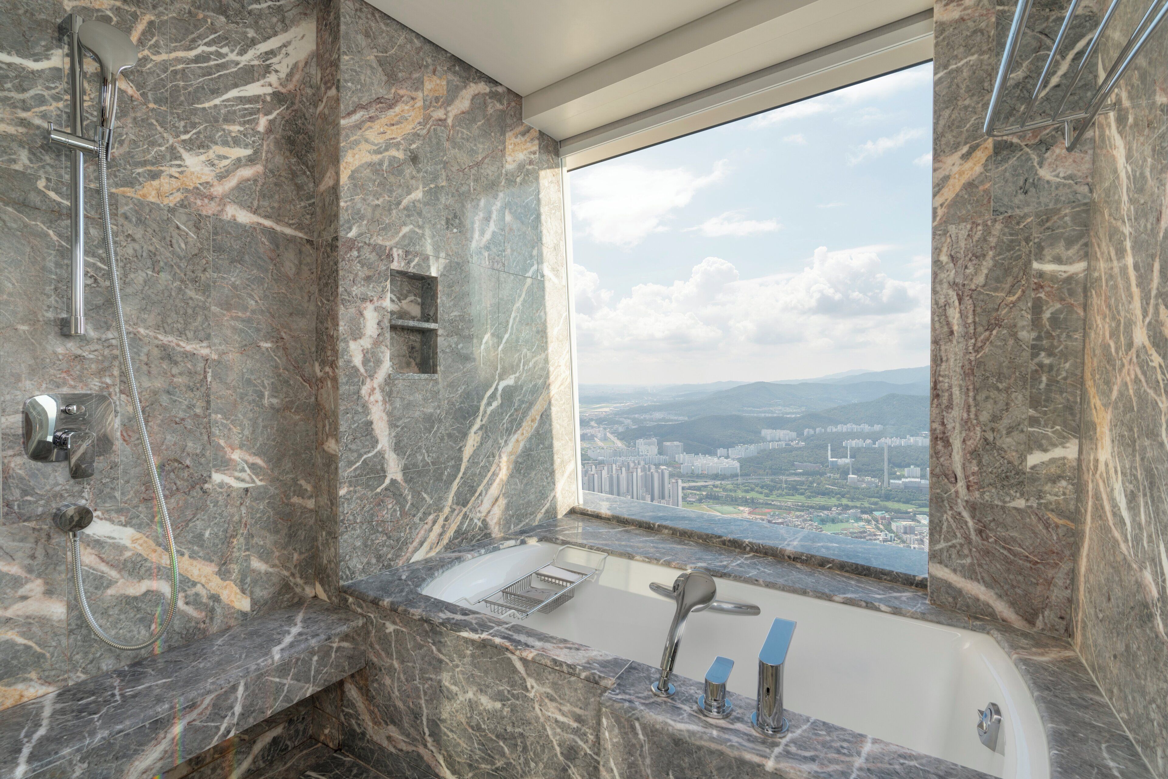 A bathroom with a marble sink, a shower, and a bathtub.
