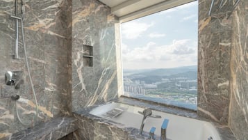 A bathroom with a marble sink, a shower, and a bathtub.