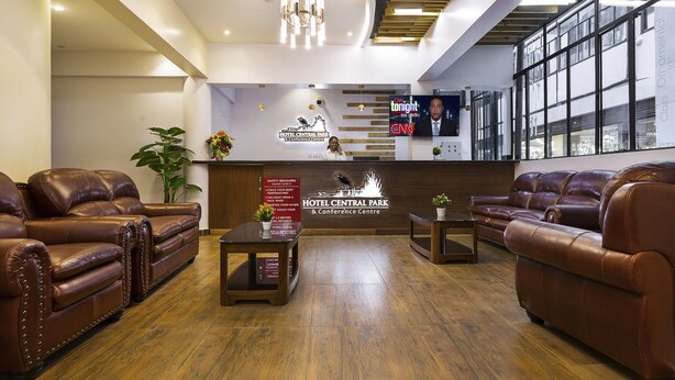 A lobby with leather sofas, a reception desk, and a CNN TV screen.