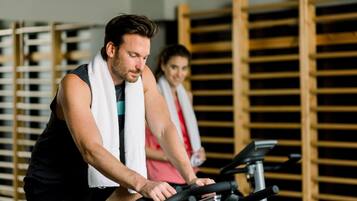 A gym with exercise equipment and wooden racks in the background.
