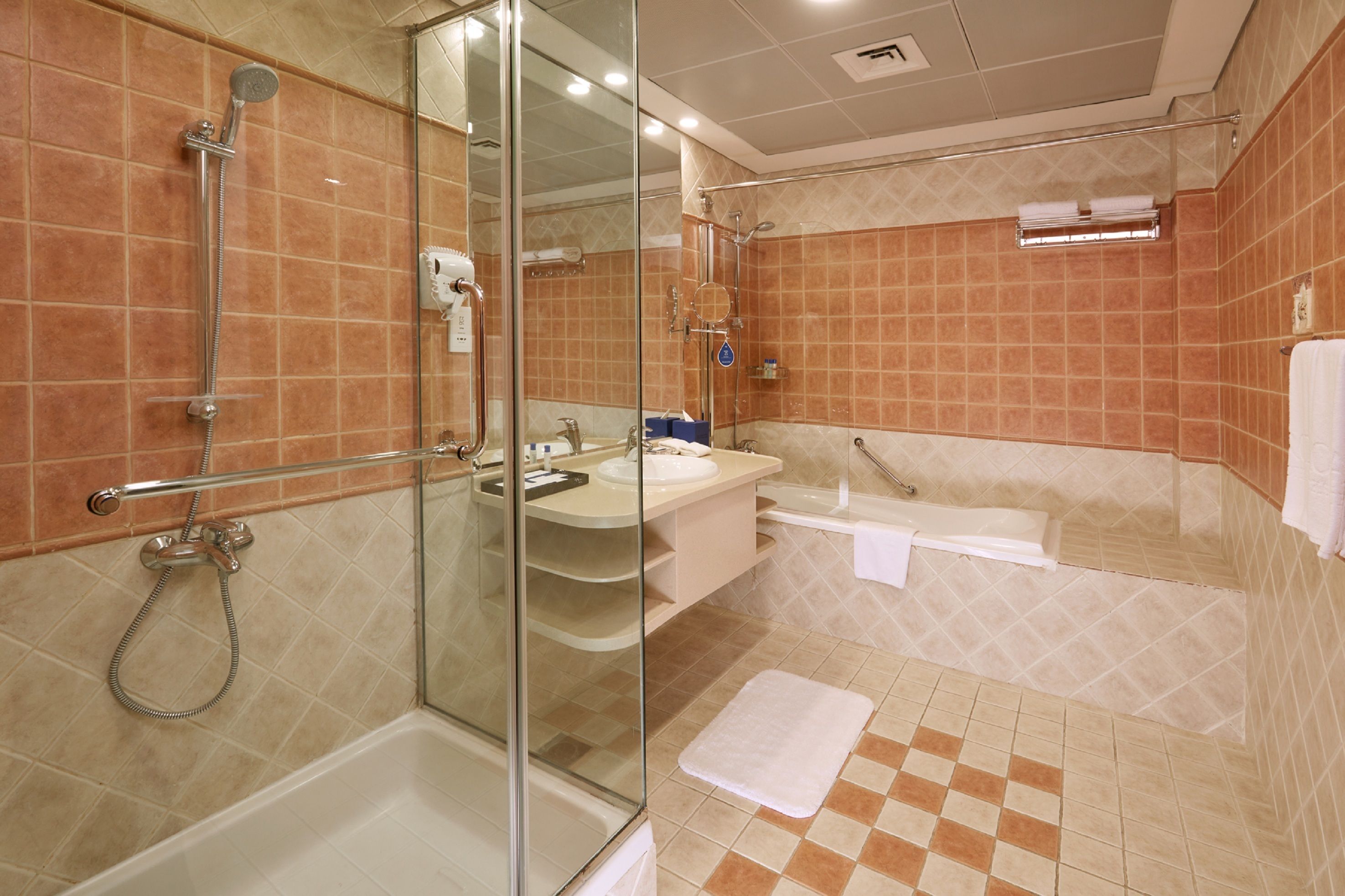 A modern bathroom with a glass-enclosed shower, a bathtub, and a vanity with a sink.
