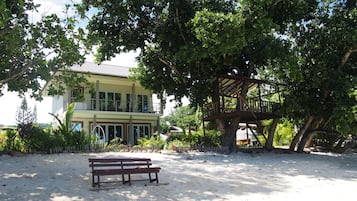 On the beach, white sand, sun loungers, beach towels