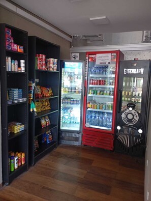 A vending area with snack and drink options, including a Coca-Cola refrigerator and a Eisenschmuck vending machine. - Bravo City Hotel Dourados (Dourados)