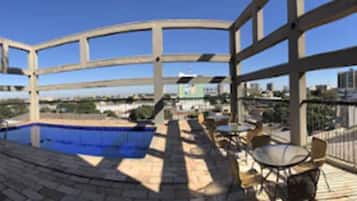 Relax on the covered terrace with a pool and city views.