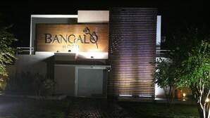 A modern building with a sign reading "BANGAL" and "HOTEL" indicating a hotel establishment.