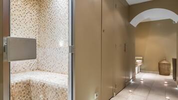 Enjoy a refreshing shower in this bathroom featuring a walk-in closet and recessed lighting.