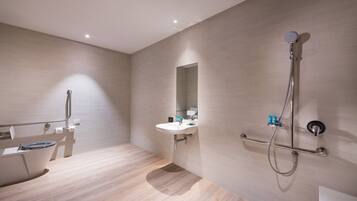 A modern bathroom with a bathtub, a sink, and a shower.