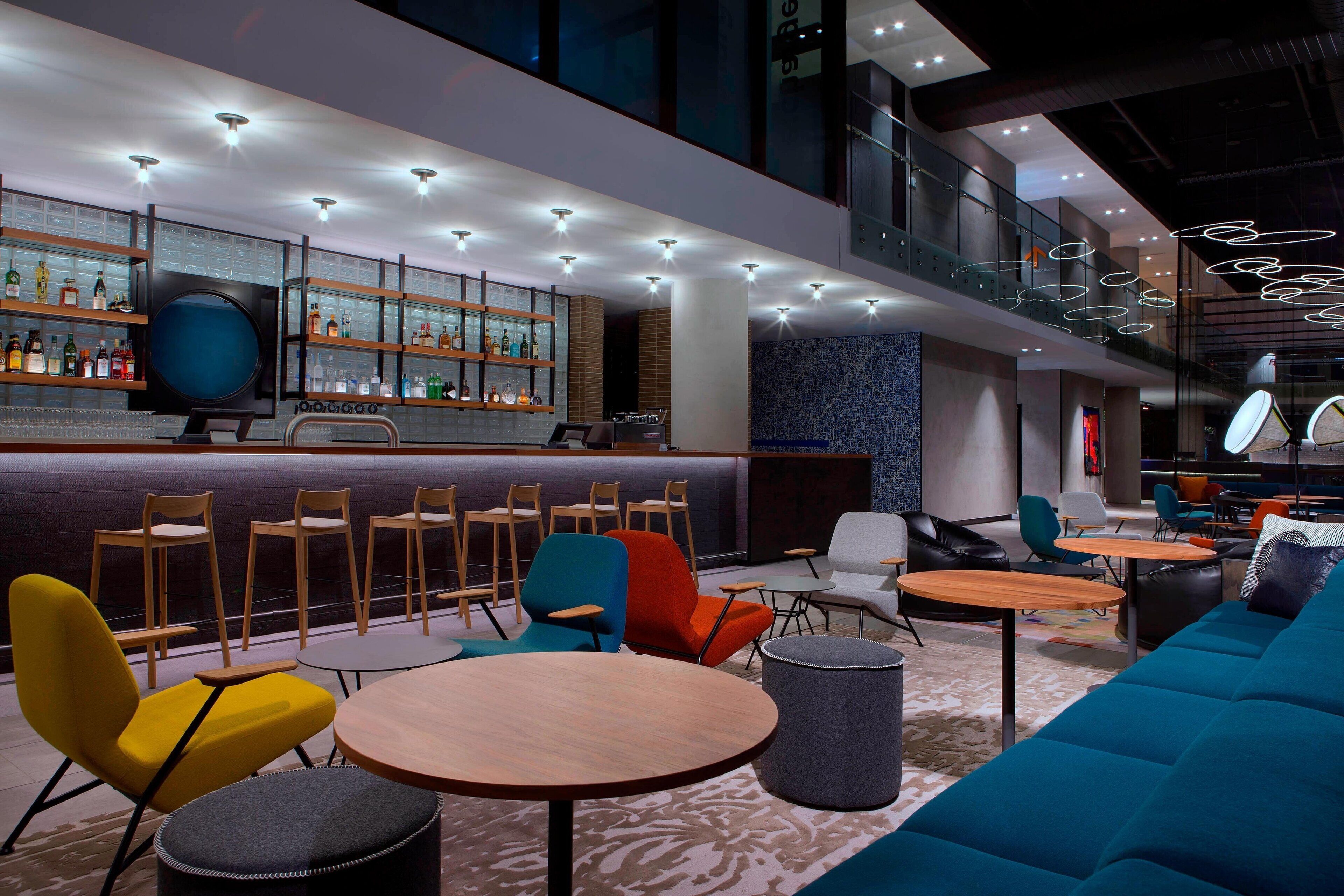 A modern bar area with seating and a bar counter.
