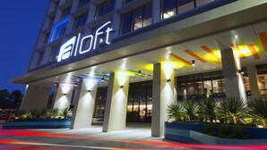 A hotel entrance with a modern design, featuring a prominent 'a loft' sign and a colorful ceiling. - Aloft by Marriott Perth (Rivervale)