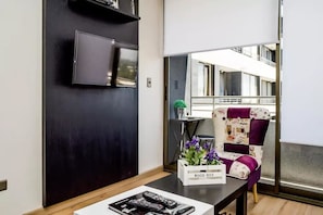 Standard Apartment, 1 Bedroom | Living area | Flat-screen TV - Altos Alameda apartments (Santiago)