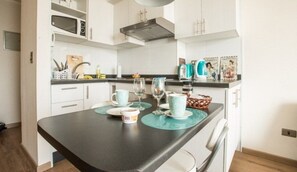 Standard Apartment, 2 Bedrooms, Accessible, Balcony | Living area | Flat-screen TV - Altos Alameda apartments (Santiago)