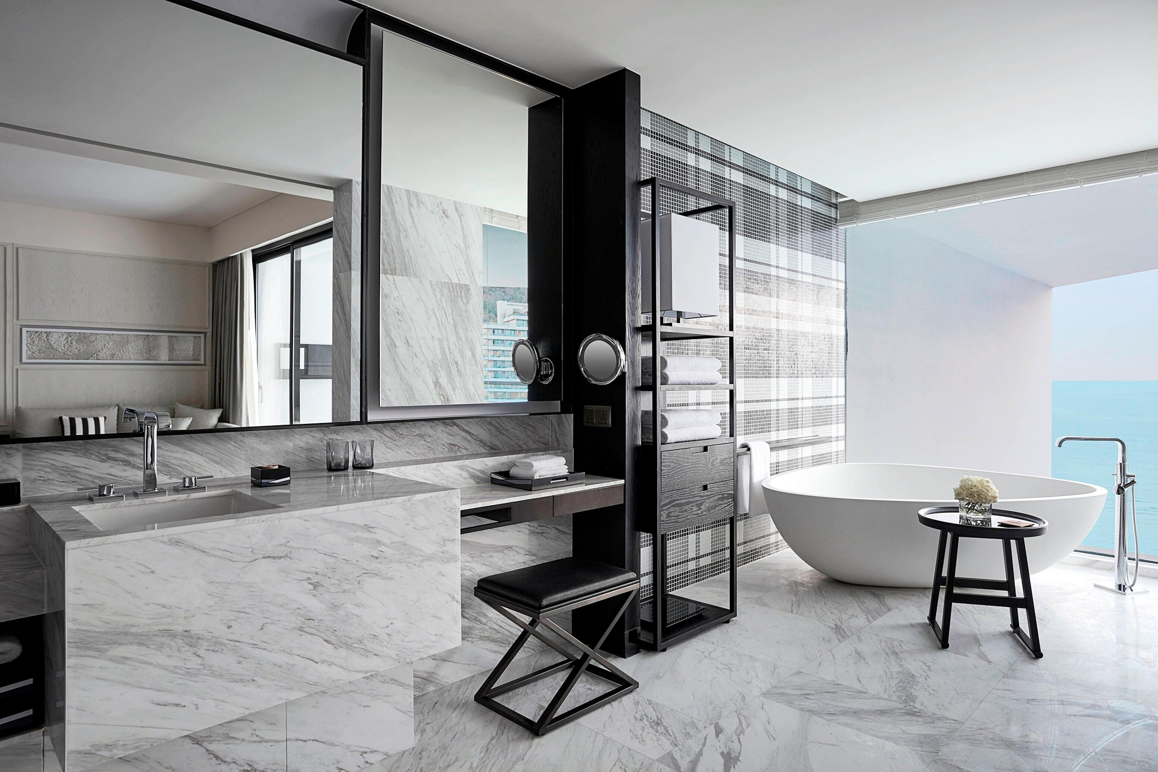 A modern bathroom with a large bathtub, a walk-in shower, and a vanity with a mirror.