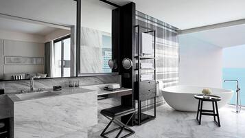 A modern bathroom with a large bathtub, a walk-in shower, and a vanity with a mirror.