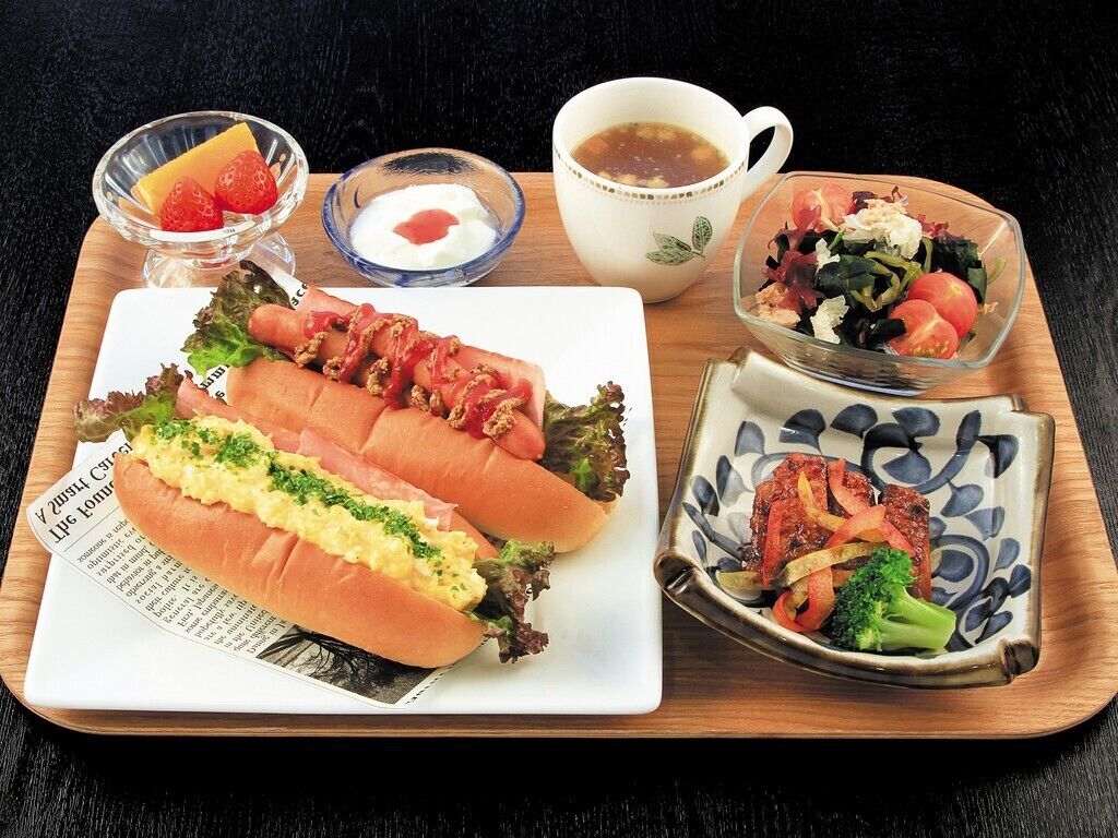 Un plateau avec un sandwich, une salade et une soupe.