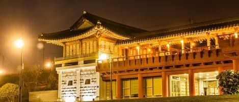 A traditional building with a prominent entrance and a balcony area.
