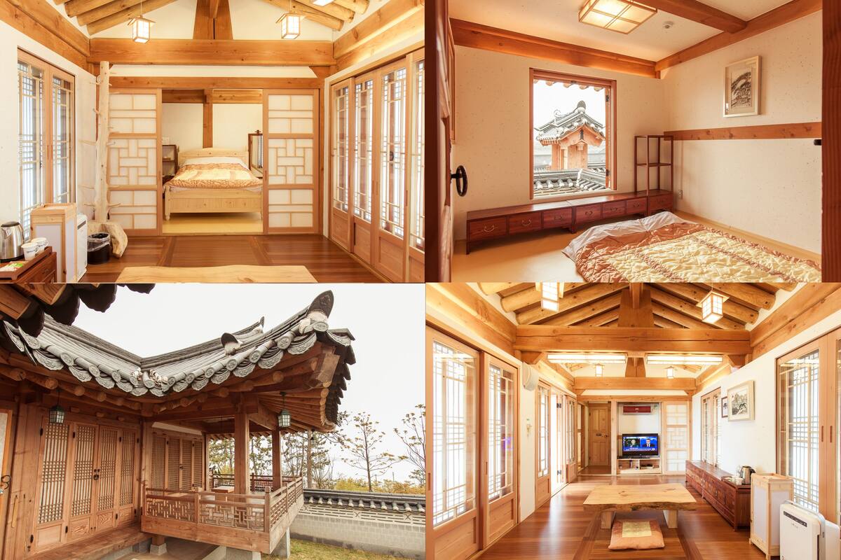 A traditional Japanese-style room with tatami flooring, a wooden bed with a canopy, sliding doors, and a view of a traditional building outside.