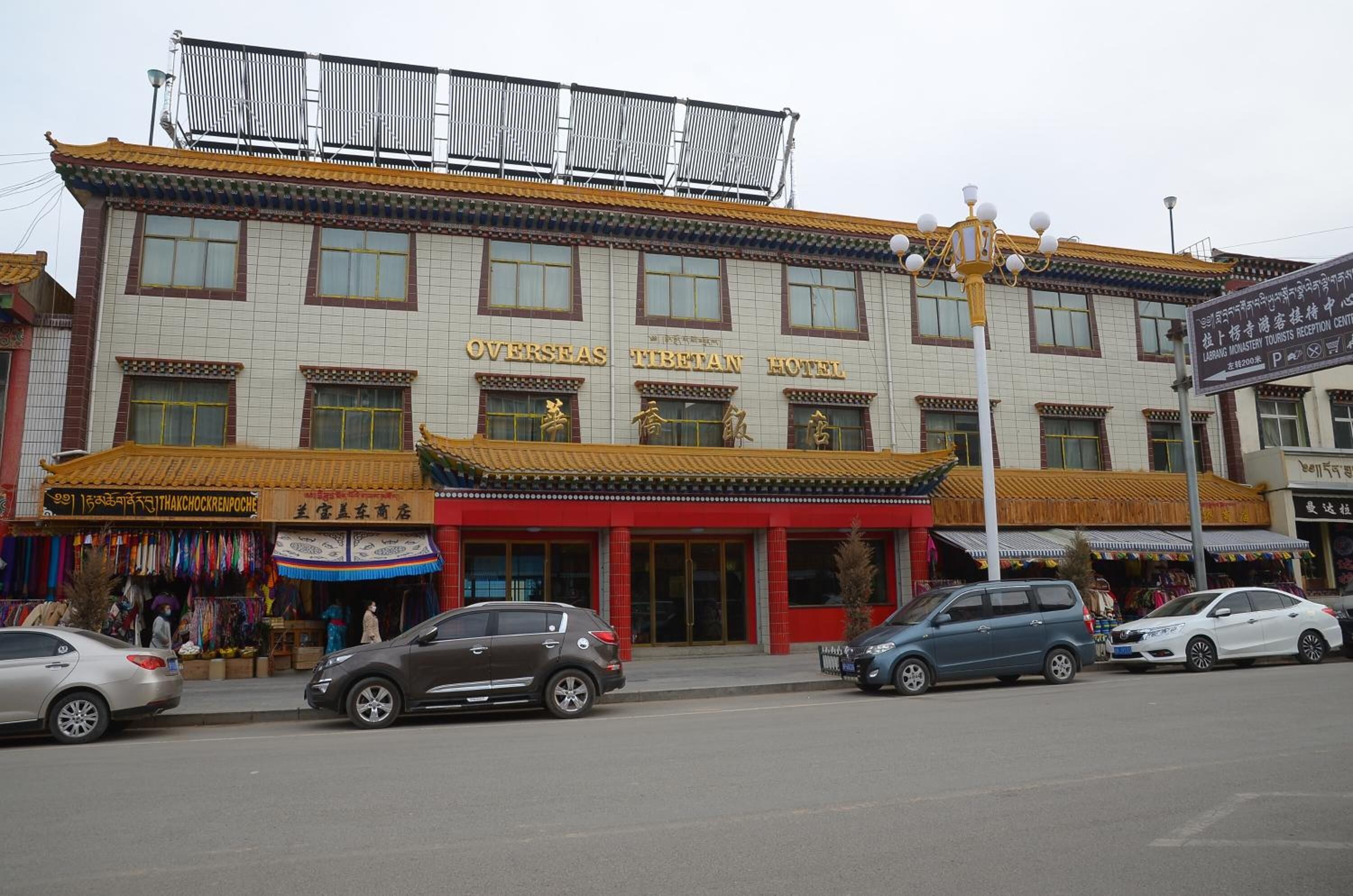 A building with a sign reading "Overseas Tibetan Hotel".