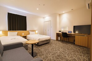 A hotel room with two beds, a desk, a chair, a TV, and a small table. - Sakura Garden Hotel (Osaka)